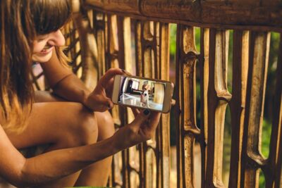 Woman using her smartphone to check on her dog