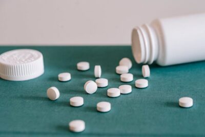 Pills spilled out of white jar