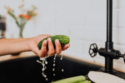 Washing Cucumber under Tap Water 