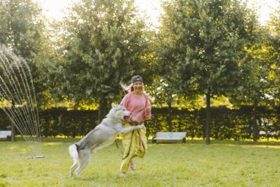 Woman playing with her Husky dog