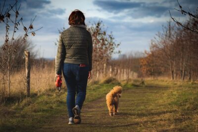 Woman walking with her Cavapoo pup